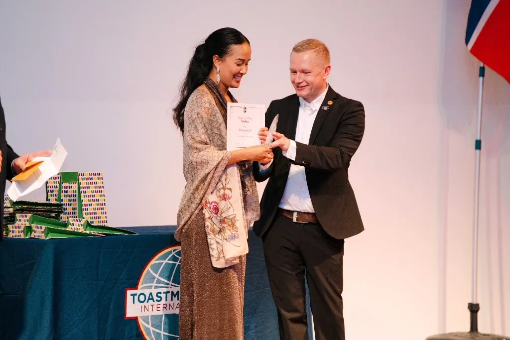 A participant receiving recognition during a Toastmasters event